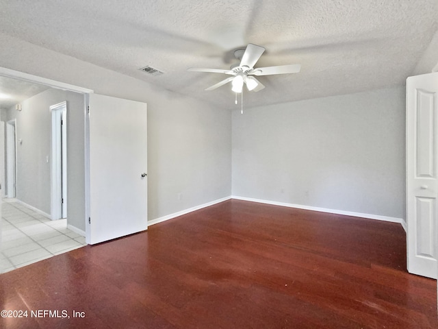 unfurnished room with ceiling fan, light hardwood / wood-style floors, and a textured ceiling