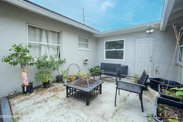 view of patio / terrace featuring an outdoor living space with a fire pit