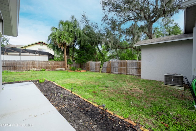 view of yard with a patio area and central air condition unit