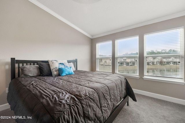 carpeted bedroom with vaulted ceiling and ornamental molding