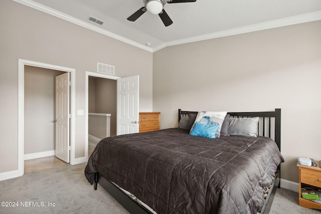 carpeted bedroom with ceiling fan, ornamental molding, and vaulted ceiling