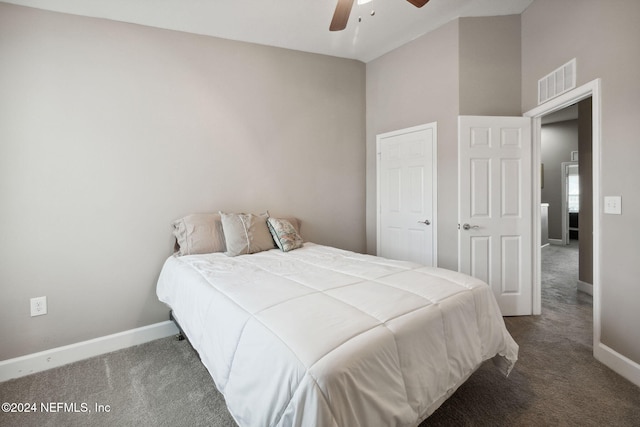 bedroom featuring ceiling fan, dark carpet, and high vaulted ceiling