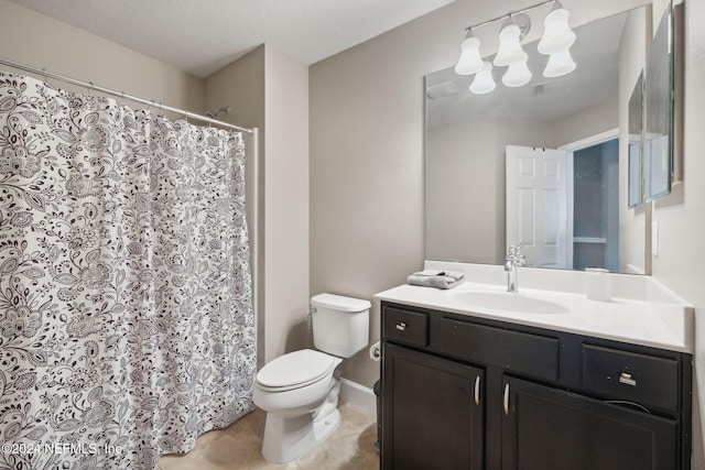 bathroom featuring tile patterned flooring, vanity, toilet, and a textured ceiling