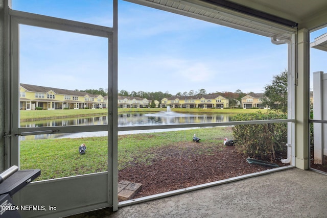 unfurnished sunroom with a water view