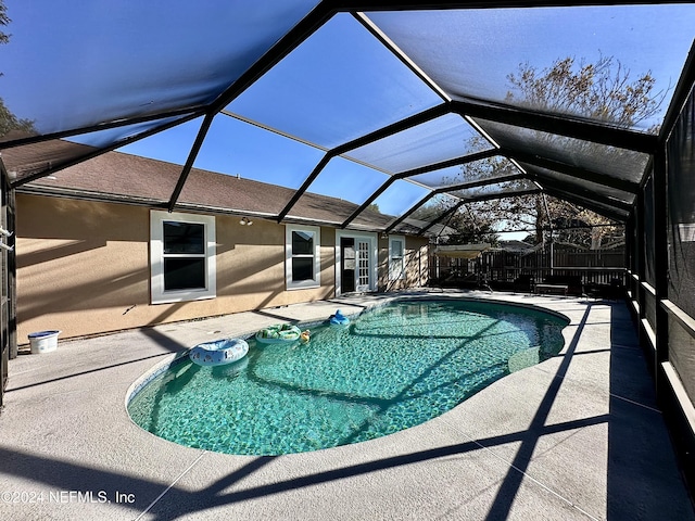 view of pool with a patio area and a lanai