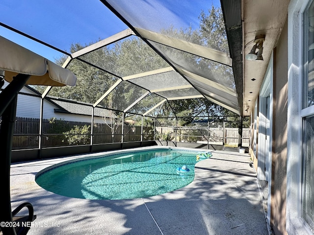 view of pool featuring a lanai and a patio area