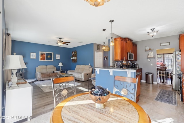 dining space featuring ceiling fan and light hardwood / wood-style floors