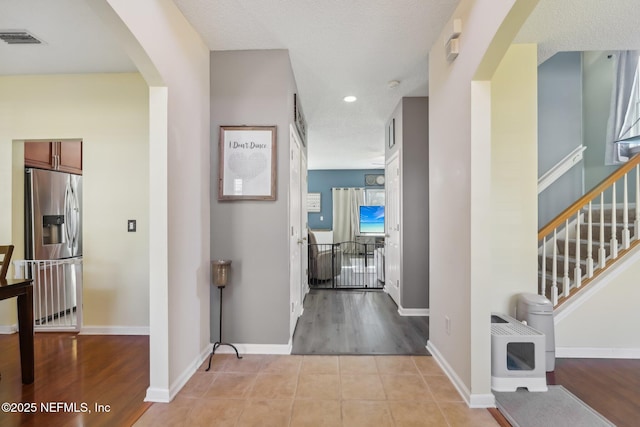 hall with light tile patterned floors