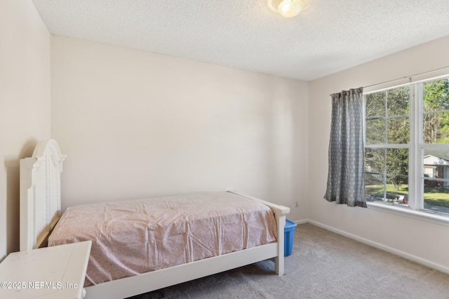 bedroom with carpet and a textured ceiling