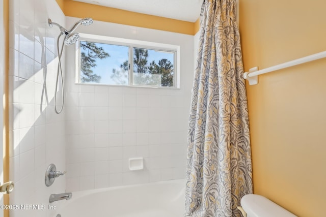 bathroom with toilet and shower / tub combo with curtain