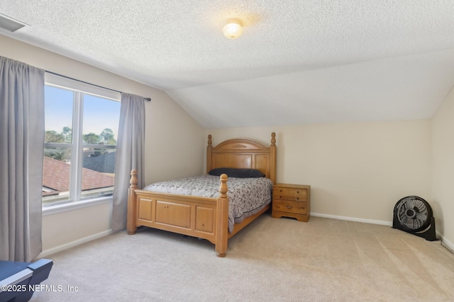 bedroom featuring multiple windows, light colored carpet, and lofted ceiling