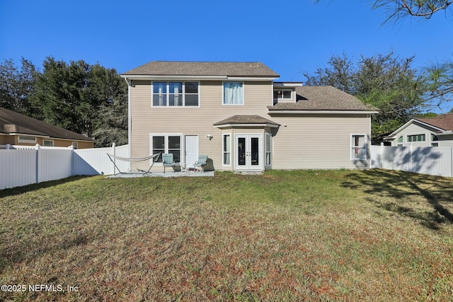 back of house with a lawn, a patio area, and french doors