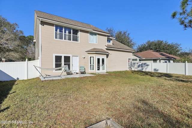 back of property featuring a lawn, french doors, and a patio