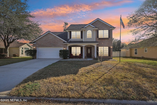 view of front property with a yard and a garage