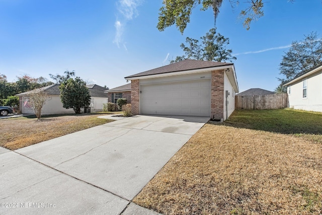 ranch-style house with a garage and a front yard