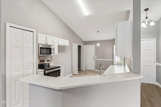 kitchen with kitchen peninsula, stainless steel appliances, white cabinetry, and hanging light fixtures