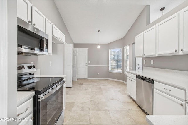 kitchen with white cabinets, hanging light fixtures, vaulted ceiling, and appliances with stainless steel finishes