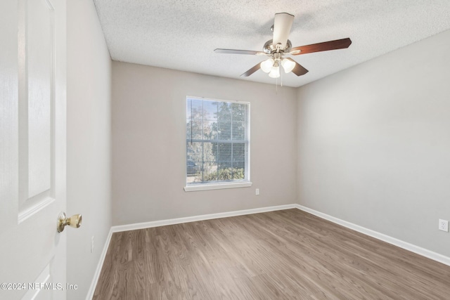 spare room featuring ceiling fan, a textured ceiling, and hardwood / wood-style flooring