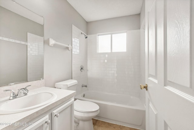 full bathroom with tile patterned flooring, vanity, toilet, and tiled shower / bath combo