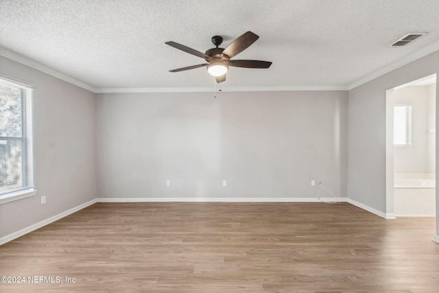 empty room with ceiling fan, crown molding, light hardwood / wood-style floors, and a textured ceiling