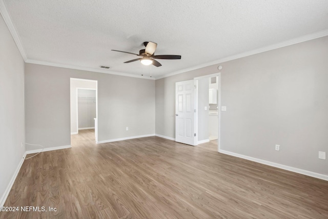 unfurnished room with a textured ceiling, ceiling fan, wood-type flooring, and crown molding