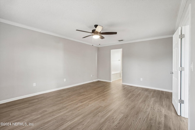 spare room featuring ceiling fan, hardwood / wood-style floors, a textured ceiling, and ornamental molding