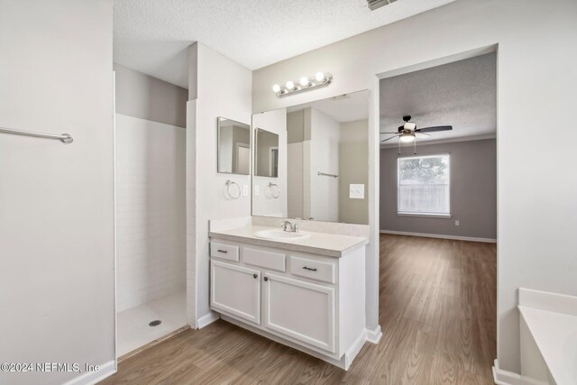 bathroom featuring vanity, a textured ceiling, hardwood / wood-style flooring, and ceiling fan