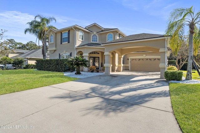 view of front of property with a garage and a front lawn