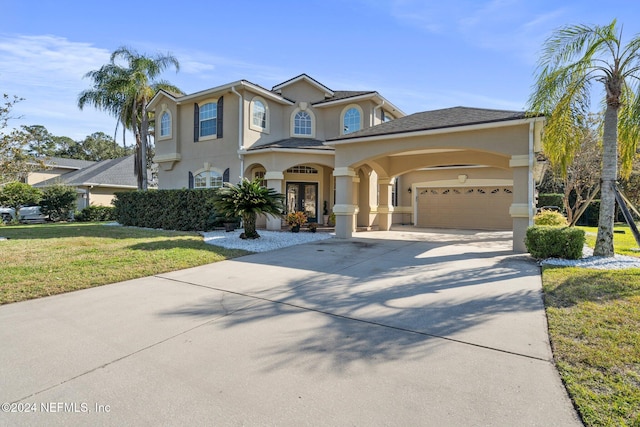 view of front of property featuring a garage and a front yard