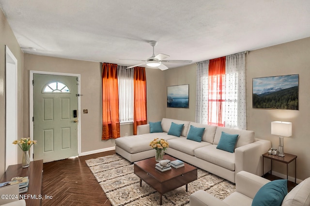 living room featuring ceiling fan, parquet floors, and a textured ceiling