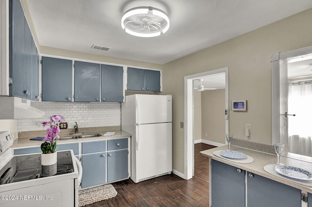 kitchen featuring stove, dark hardwood / wood-style flooring, ventilation hood, ceiling fan, and white fridge