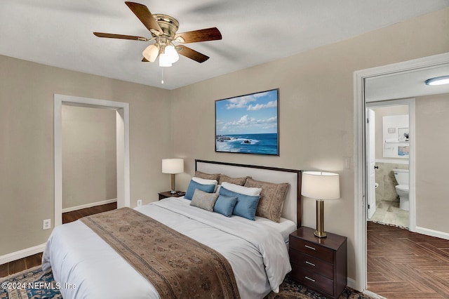 bedroom featuring dark parquet flooring, ensuite bathroom, and ceiling fan