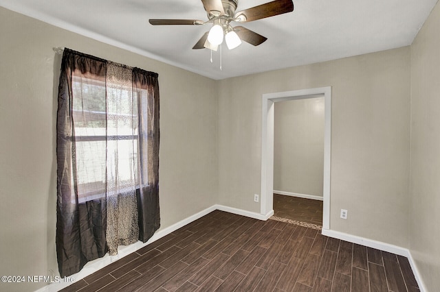 spare room featuring ceiling fan and dark hardwood / wood-style floors