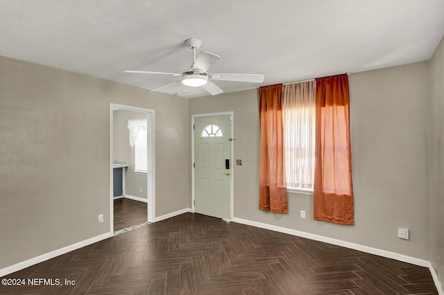 entrance foyer with dark parquet floors and ceiling fan