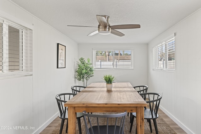 dining area featuring hardwood / wood-style flooring, plenty of natural light, a textured ceiling, and ceiling fan