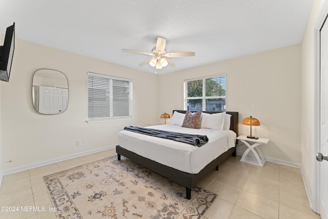 bedroom featuring light tile patterned floors and ceiling fan