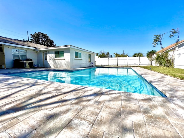 view of pool featuring grilling area