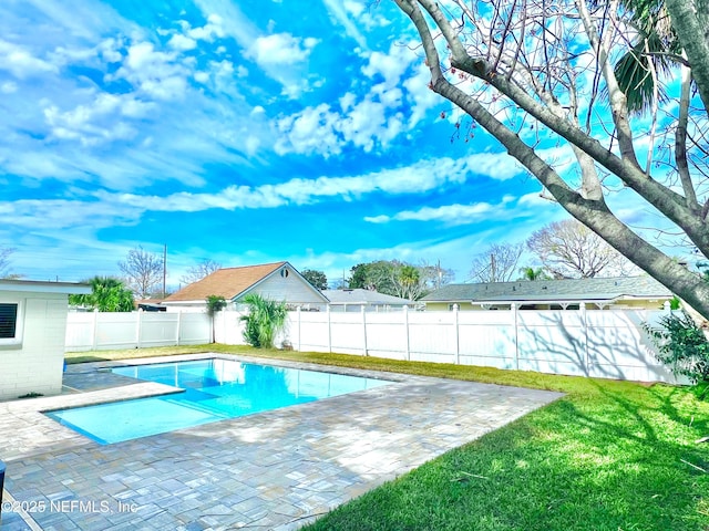 view of pool with a yard and a patio area