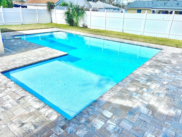 view of swimming pool featuring a patio area