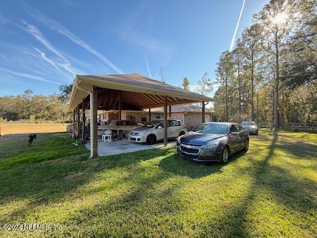 view of car parking featuring a lawn and a carport