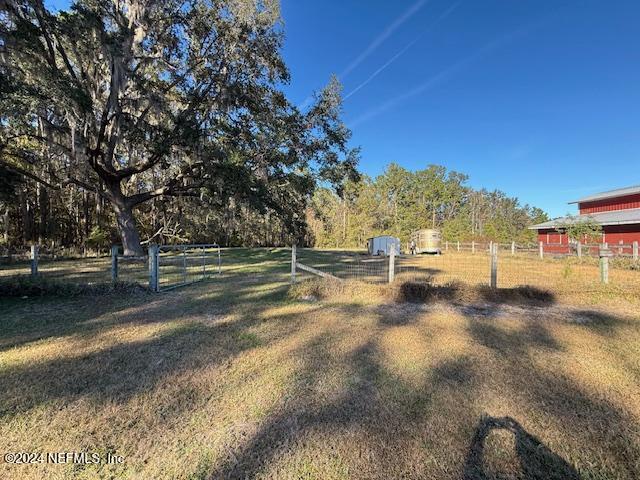 view of yard featuring a rural view and fence