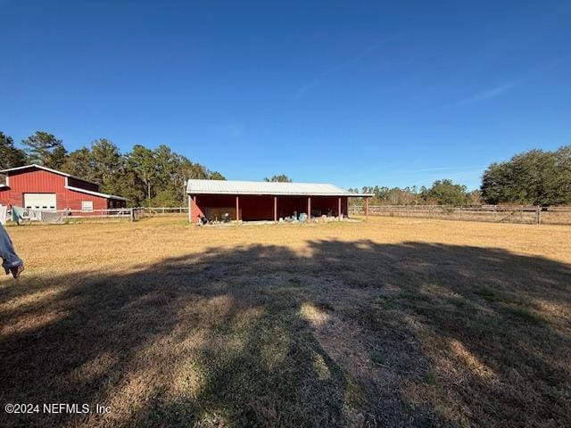 view of yard with a rural view and an outbuilding