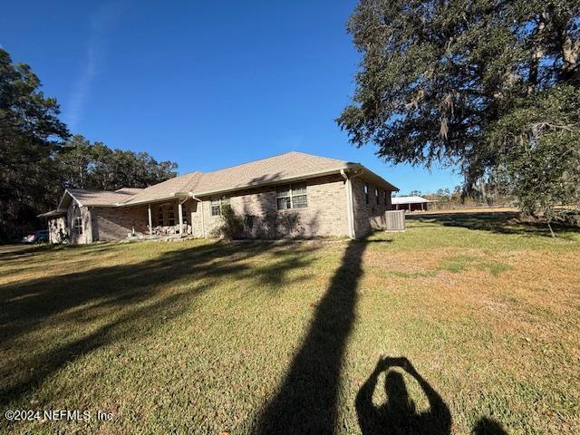 view of side of home with a lawn