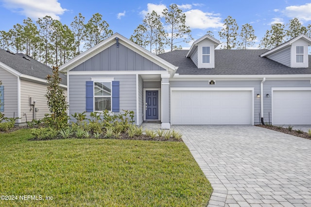 view of front facade with a garage and a front lawn