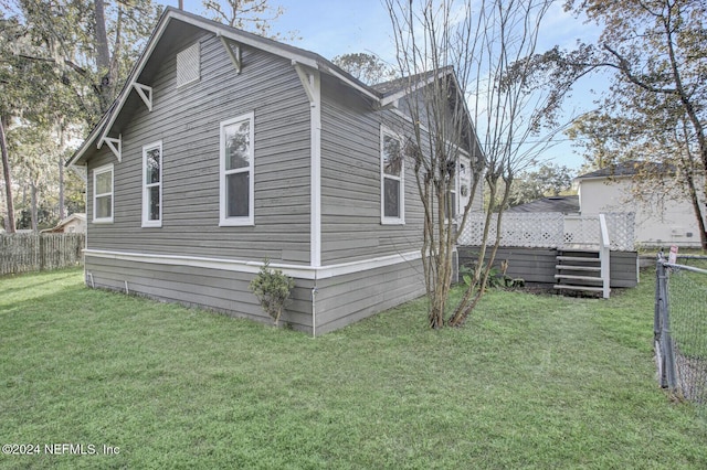 view of side of property with a lawn