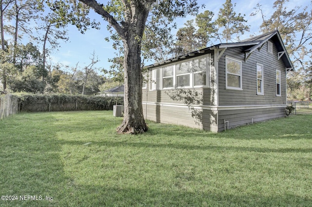 view of property exterior featuring cooling unit and a yard