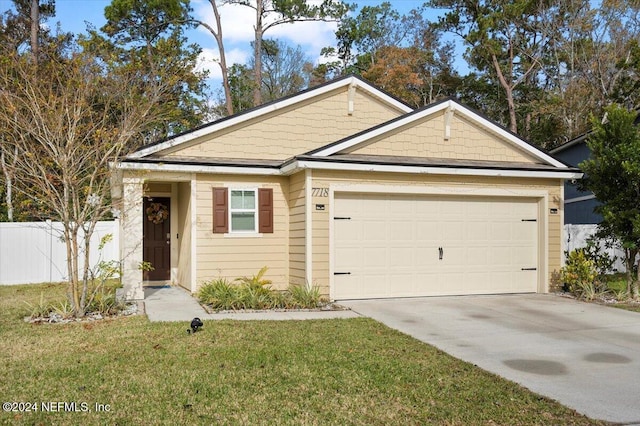 view of front of home featuring a garage and a front yard