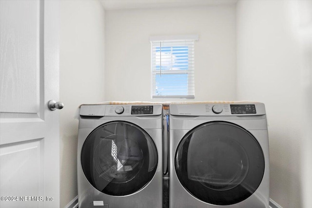 laundry room featuring washing machine and clothes dryer