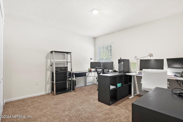 carpeted office space featuring a textured ceiling