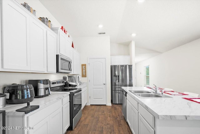 kitchen featuring dark hardwood / wood-style flooring, white cabinets, stainless steel appliances, and lofted ceiling